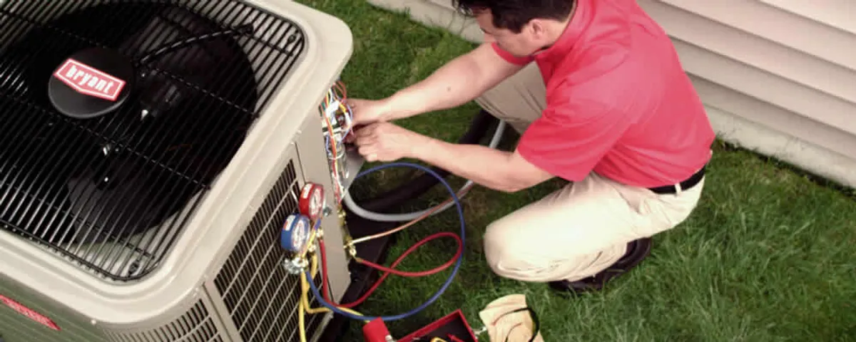 HVAC technician servicing an outdoor air conditioner unit in Boulder, CO